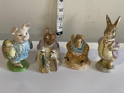 A assortment of Beswick and Royal Albert Beatrix Potter figurines, shipping unavailable