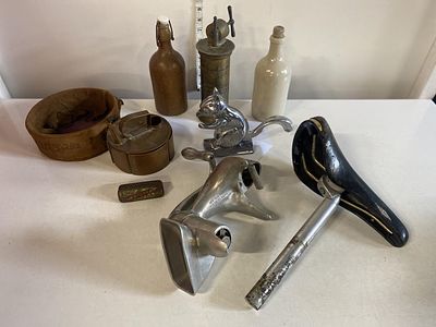 A box of assorted collectibles vintage bike saddle by San Marco, nutcracker etc, shipping