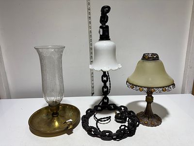 Three assorted lighting fixtures comprising an Arts and Crafts style boudoir lamp, a brass 