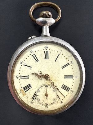 שעון כיס עתיק. קייס מעוטר חריטות. מנגנון במצב עבודה חלקי (רץ ועוצר לאחר מספר שניות). קוטר: 5 ס"מ.