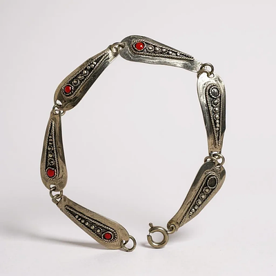 צמיד כסף סטרלינג 925 מעוטר פיליגרן. ישראל שנות ה50. חתום. חוסר ב2 חרוזים אדומים. אורך: 18 ס"מ. 