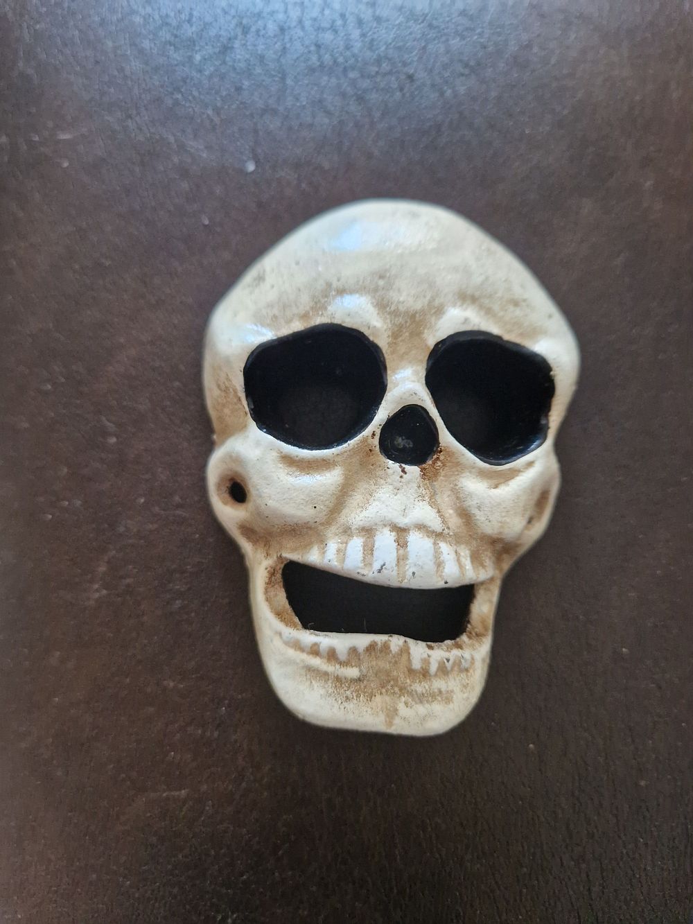 Lot 213: Cast iron skull bottle opener