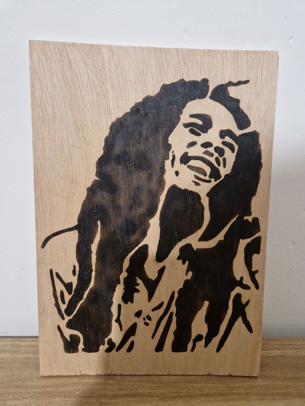 Lot 216: Wooden burnt in bob Marley picture