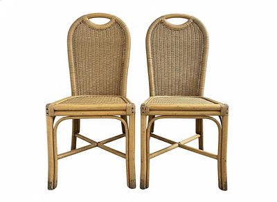 An elegant pair of chairs with an exotic and refined appeal, made of curved rattan and bamboo. 