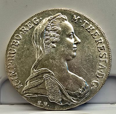 תאלר מריה תרזה 1780 – מהדורה חוזרת (Restrike) 
מטבע כסף איקוני של הקיסרית מריה תרזה, הנושא את 