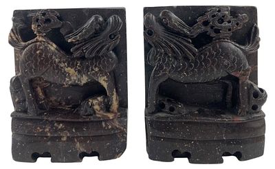 Pair of Carved Stone Qilin Bookends. Pair of Asian carved dark stone bookends featuring mythical 