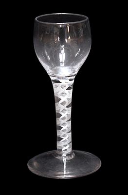 A mid 18th century English wine glass with tulip bowl on double series white opaque twist stem 