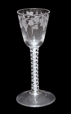 A mid 18th century English wine glass with rounded funnel bowl etched with a band of fruiting 