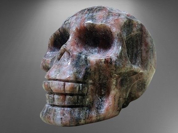 Skull sculpted in Black Exotica Jasper natural crystal gemstone. Item made from one unit of