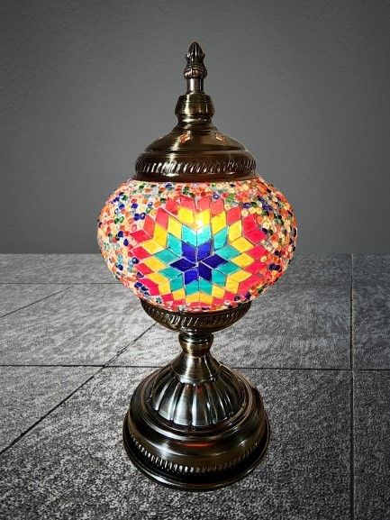 Table lamp inlaid with colored glass mosaic pieces. A quality and impressive item. 
Height 28 cm 