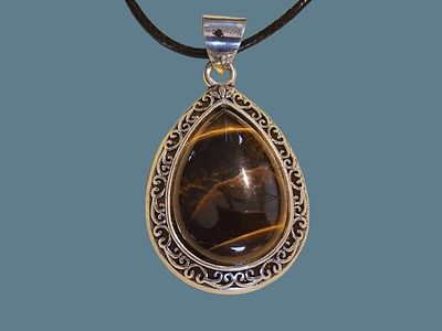 Drop-shaped Tiger's Eye pendant with silver-plated metal frame. Average size of the pendant is 4 