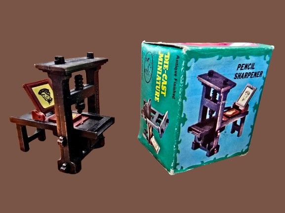 Vintage pencil sharpener made of bronze-tone cast metal - antique printing press in the 