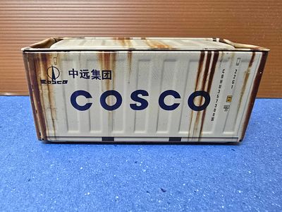 Miniature metal sea container - Chinese shipping company. The container opens with a top lid and 