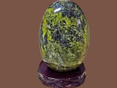 Large green opal stone "Pistachio Opal" placed on a wooden stand - rare. Original and natural. 