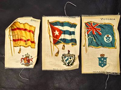 Items from 1910 - Embroidered fabric with country flags. An item made for tobacco boxes in 