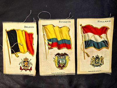 Items from 1910 - Embroidered fabric with country flags. An item made for tobacco boxes in 