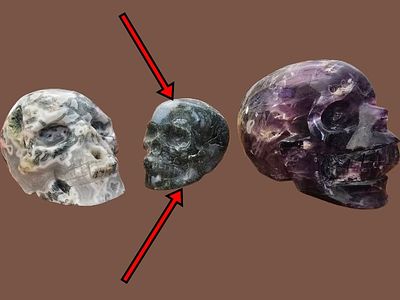 Sculpture of a skull carved from moss agate stone. The item in this sale is marked with a red 