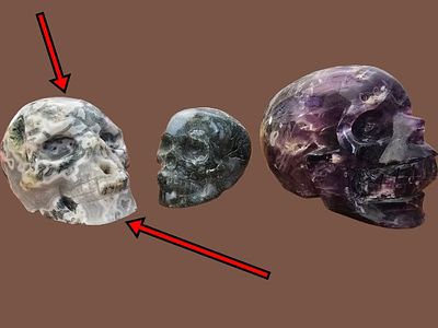 Sculpture of a skull carved from moss agate stone. The item in this sale is marked with a red 