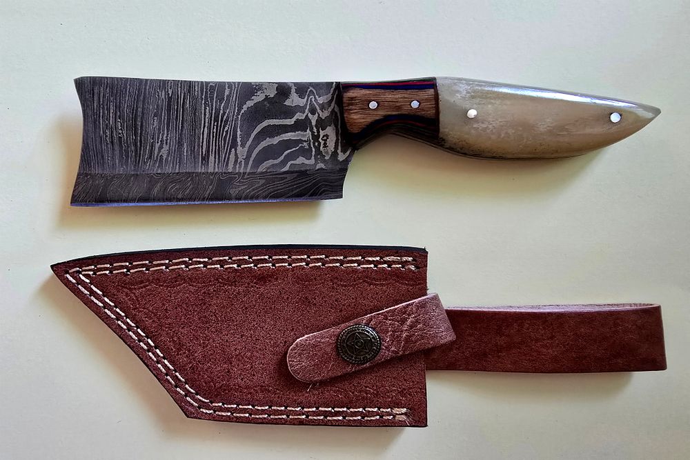 A small hunting knife designed from handmade Damascus steel, including a deer bone handle - 