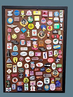 A collection of pins and flags framed with vintage glass covering from the years 1945-1979. Food 