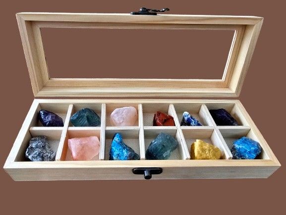 A collection of natural gemstones and crystals without processing or polishing in a wooden box 