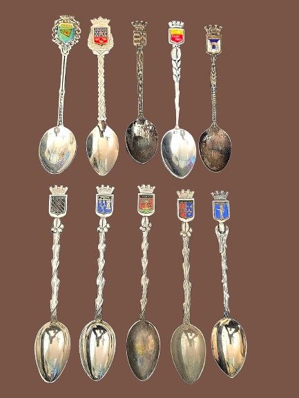 A collection of souvenir spoons from around the world. Emblems and city symbols: Many of the 