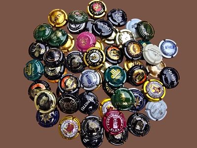 A collection of metal stoppers (also known as "plaques") placed on the corks of sparkling wine 