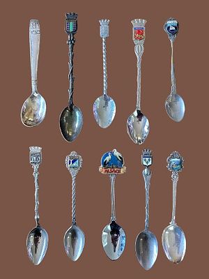 A collection of souvenir spoons, which are decorative objects used as mementos from historical 