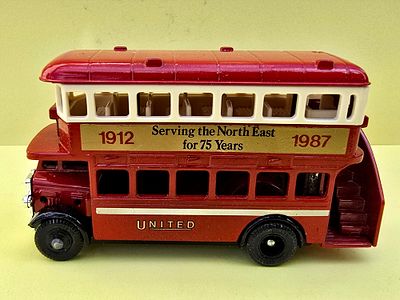 A collectible die-cast double-decker bus model, representing a Scottish tour bus branded 