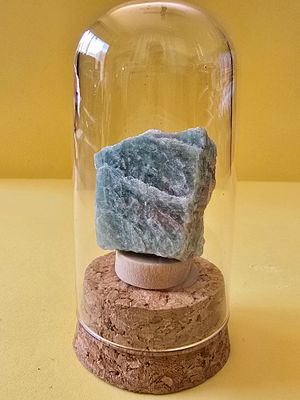 Original raw, unprocessed Amazonite gemstone. In a glass capsule. The capsule is 8 cm high. 