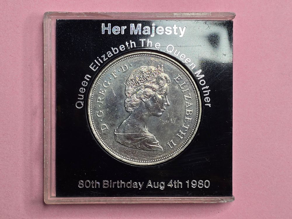 A British "Crown" coin from 1980, issued to commemorate the 80th birthday of the Queen Mother 
