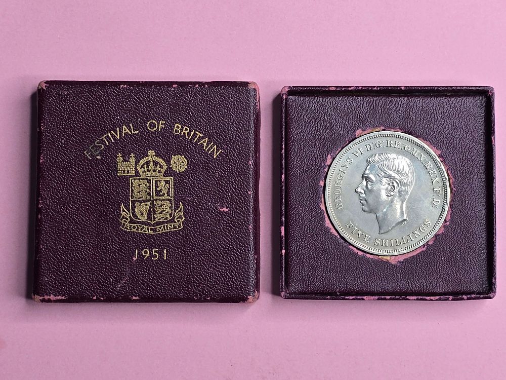 A "Crown" commemorative coin issued in 1951 in honor of the "Festival of Britain". Denomination: 