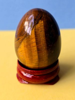 Natural Tiger Eye Gemstone Sculpted in the Shape of an Egg. Includes display base. 
The battery 