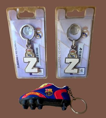 Collectible items from Spanish football teams - Barcelona and Real Madrid branded key chains. Tw 