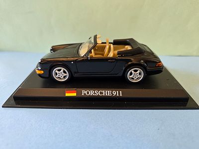 A collectible diecast model of a Porsche 911 Carrera 4 Cabriolet. The model is produced by 