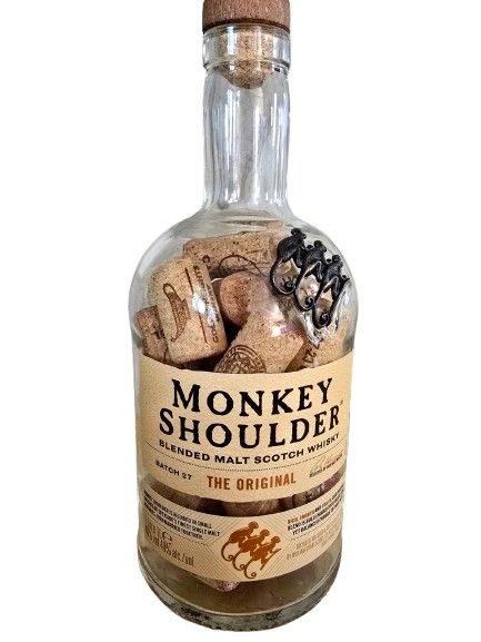 A whiskey bottle filled with corks from mainly Israeli wines. The height of the bottle is 27 cm.