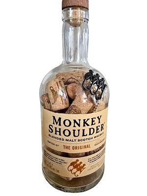 A whiskey bottle filled with corks from mainly Israeli wines. The height of the bottle is 27 cm.