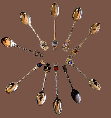 A collection of souvenir spoons representing various historical and geographical destinations 