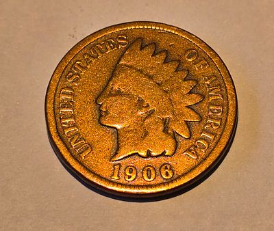 American "Indian Head Cent" coin from 1906. The coin depicts the image of "Liberty" wearing a 