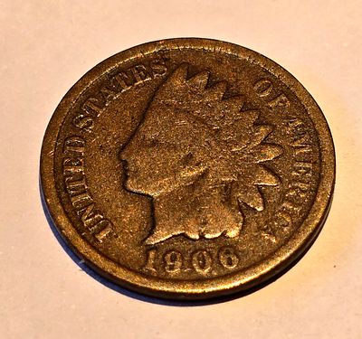 American "Indian Head Cent" coin from 1906. The coin depicts the image of "Liberty" wearing a 