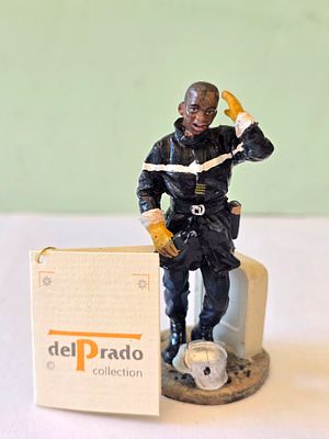 The rare series - a metal figurine of a firefighter from Ivory Coast from 1999, signed, made by 