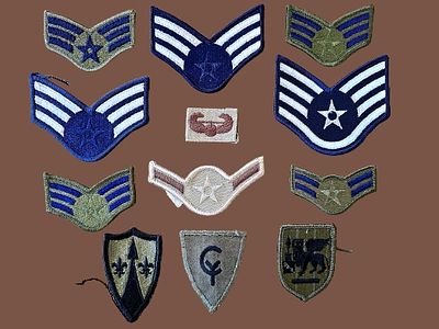 A collection of ranks and embroidered patches belonging to various branches of the United 