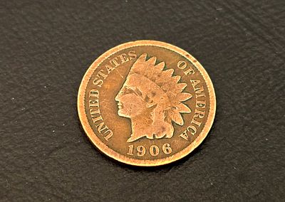 A 1906 "Indian Head Cent" coin from the United States. The design, featuring the figure of 