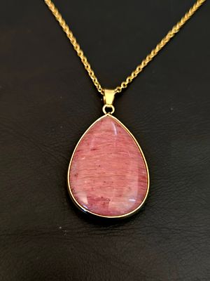 A natural pink gemstone pendant, most often identified as a type of Rhodonite, Rhodochrosite. A 