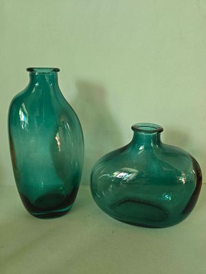 Pair of glass vases in a smoky green shade. Average height 10 to 15 cm.