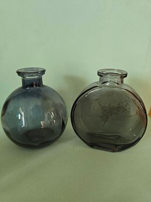 Pair of glass vases in a smoky green shade. Average height 10 to 15 cm.