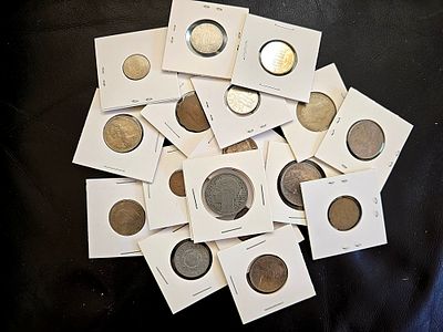 A collection of vintage coins from various countries. Coins are packaged in cardboard coin 