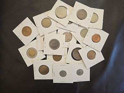 A collection of vintage coins from various countries. Coins are packaged in cardboard coin 