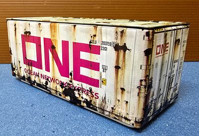 A miniature metal shipping container from the international shipping company ONE (Ocean Network 