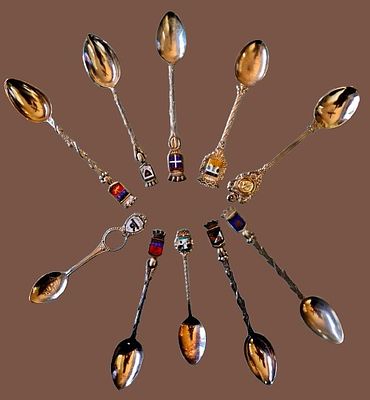 A collection of souvenir spoons representing various historical and geographical destinations 